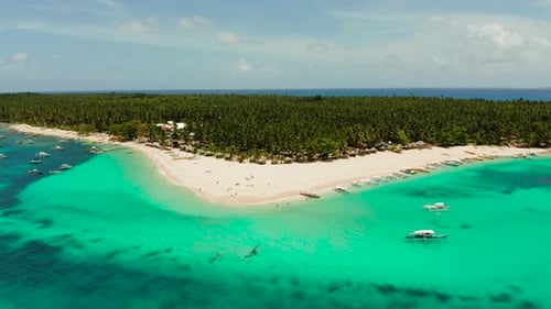 Tropical Daco Island with a Sandy Beach and Tourists