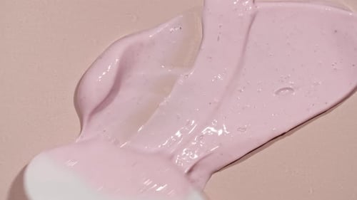 Pink Cream Spreading Using Cosmetic Spatula