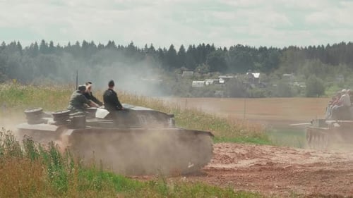 Tanks Drive Along the Sandy Road To the Battlefield