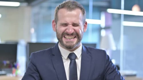Portrait of Angry Businessman Screaming Loud in Office