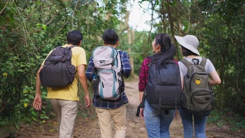 Group of young man and woman friend traveling in the forest together, walking with happiness and fun