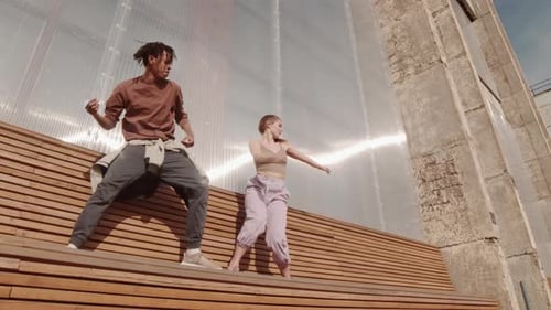 Dancers on Wooden Bench Outdoors