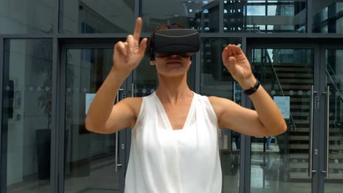 Woman Using VR Headset and Gesturing Indoors