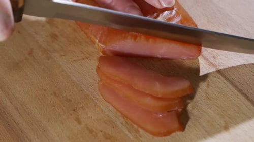 Slicing Smoked Fish on a Wooden Board