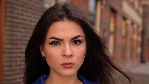 Woman Stares Seriously in Urban Close Up