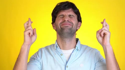 Man Crosses Fingers and Prays for Good Luck