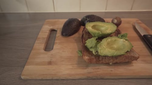 Avocado Toast On Cutting Board With Knife