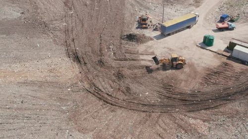 Tractor Moving Dirt at a Recycling Plant from Above