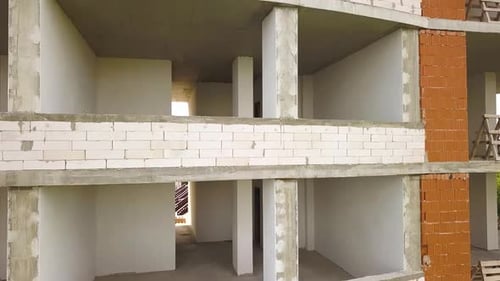 Rooms interior of new apartment building facade under construction.