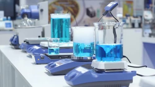 Laboratory Equipment Stirring Beakers with Blue Liquid