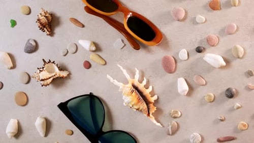 Female straw hat and sunglasses lie on beach sand. Travel summer accessories with copy space, flat