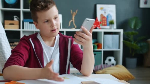 Boy Talking Via Video Call On Cellphone