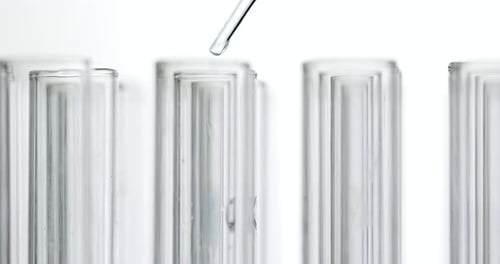 Liquid Dropping into Test Tubes in Laboratory Close Up