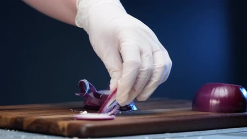 Slicing Purple Onions on a Wooden Cutting Board