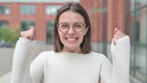 Excited Woman Celebrates Success Outdoor