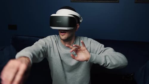 Man Wearing VR Headset and Playing Game