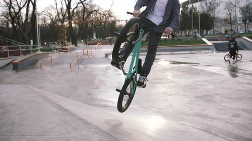 BMX Rider Doing Tricks in Street Plaza Bicycle Stunt Rider in Cocncrete Skatepark Super Slow Motion