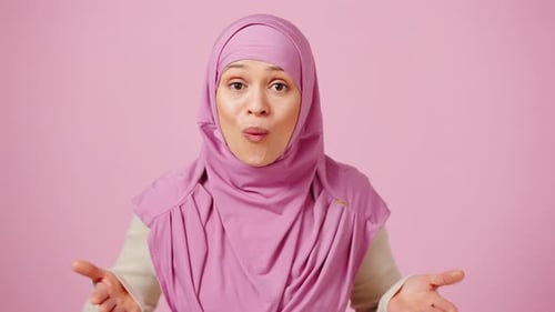 Woman in Pink Hijab Gestures and Speaks