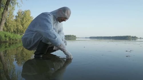 Scientist Collecting Water Sample in a Hazmat Suit