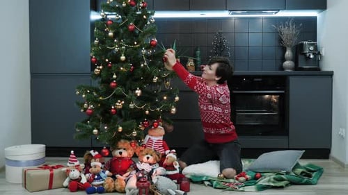 Woman Decorating Christmas Tree at Home