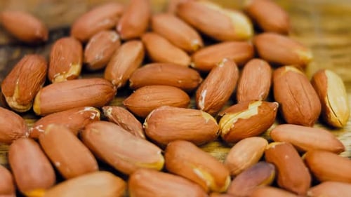 Pile of Peanuts on a Wooden Surface