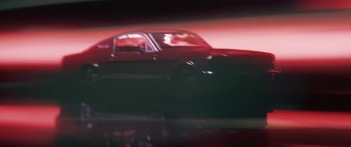 Classic Car Speeding with Streaking Red Lights