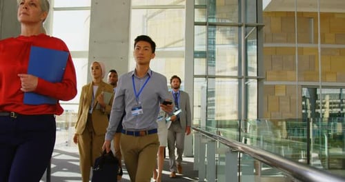 Business people walking in office building 4k