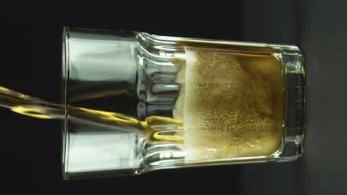 Refreshing Beverage Pours into Ribbed Glass