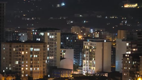 Multistorey Buildings with Changing Window Lighting At Night in City. Timelapse