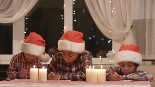 Children Writing Christmas Letters by Candle Light