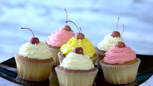 Delicious Cupcakes with Colorful Frosting and Cherries