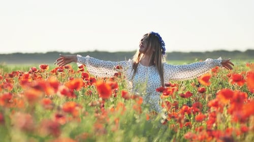 Ukrainian Girl Walking Through a Red Poppy Field