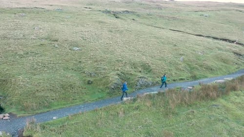 Aerial view of people hiking and climbing Snowdon mount in Wales on a sunny d