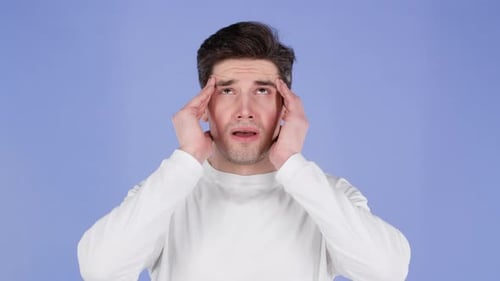 Young Man Having Headache Studio Portrait