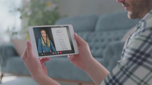 Man Video Chatting with Woman on Tablet
