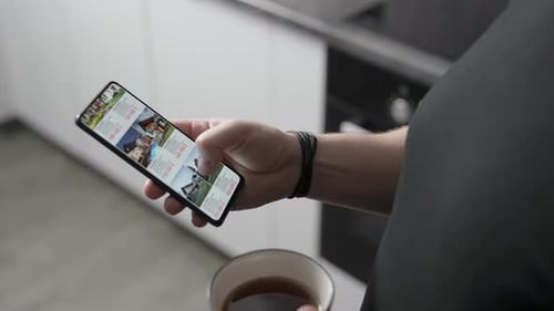 A Man Chooses a New Home for Himself Through an Application on a Smartphone