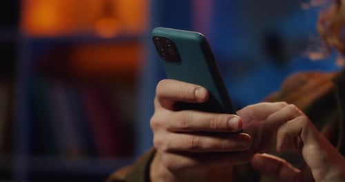 Close Up View of Males Hands Scrolling and Touching Screen While Holding Smartphone. Young Guy Using