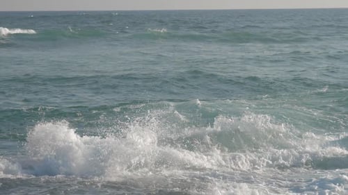 Huge Ocean Waves Roll on Beach Against Blue Sky Slow Motion