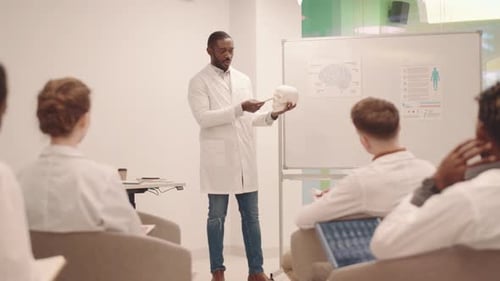 Medical Professor Lectures Students with Skull Model