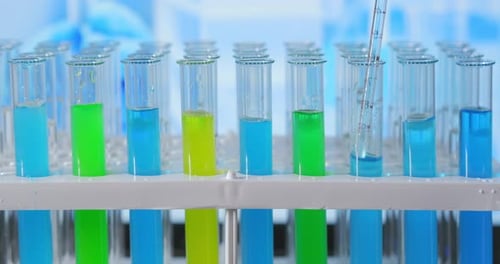 Laboratory Test Tubes with Colorful Liquids and Pipette