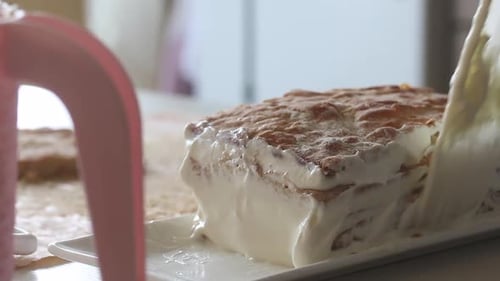 A Woman Puts Biscuit Cakes In A Pile And Spreads Cream On Them. Prepares A Puff Cake. Close Up Shot.