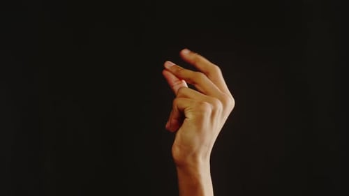 Isolated Hand Pinching Against Black Background