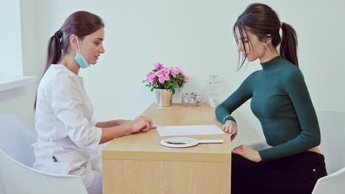 Woman Completes Medical Form in Bright Clinic Setting
