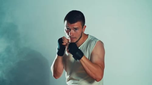 Man Boxing and Practicing Punches in Studio