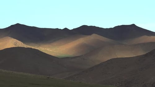 Expansive Desert Landscape with Rolling Hills and Mountains