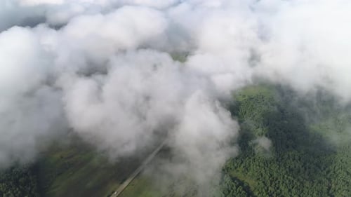 Very Slow and Smooth Flight Above the Clouds. Low Cumulus Cloud Cover. Below You Can See the Rural