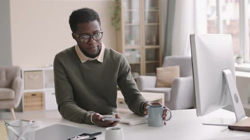 Young Adult Man Using Voice Command at Desk