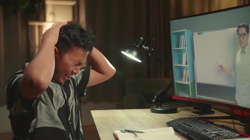 Teenage Boy Headache While Distance Learning With Online Teacher On Computer Screen From Home