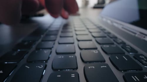 Fingers Typing on Laptop Keyboard Close Up