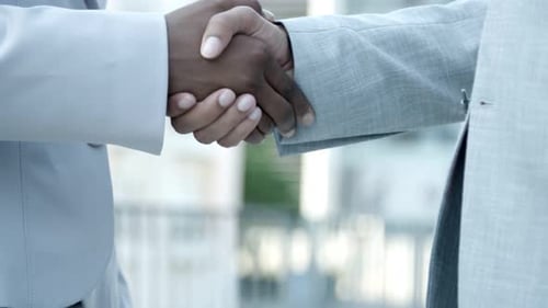 Professional Handshake Demonstrates Agreement in Urban Setting